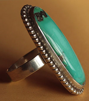 Les inclusions présentes dans la turquoise font de ce bijou western une bague d'exception.