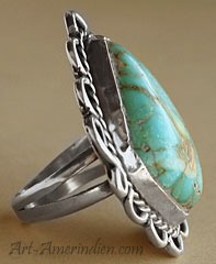Navajo ring made from turquoise and sterling silver with ethnic symbols