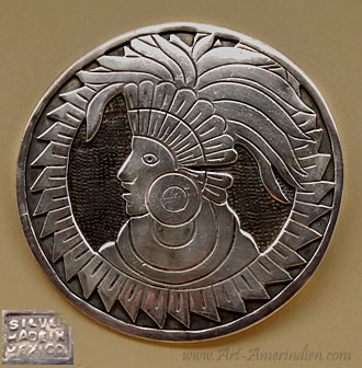 Pendentif / broche représentant un masque de querrier aztèque en argent massif.